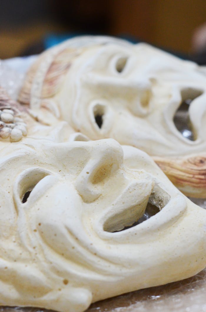 services-05 Close-up of two ceramic masks showcasing intricate designs and textures.